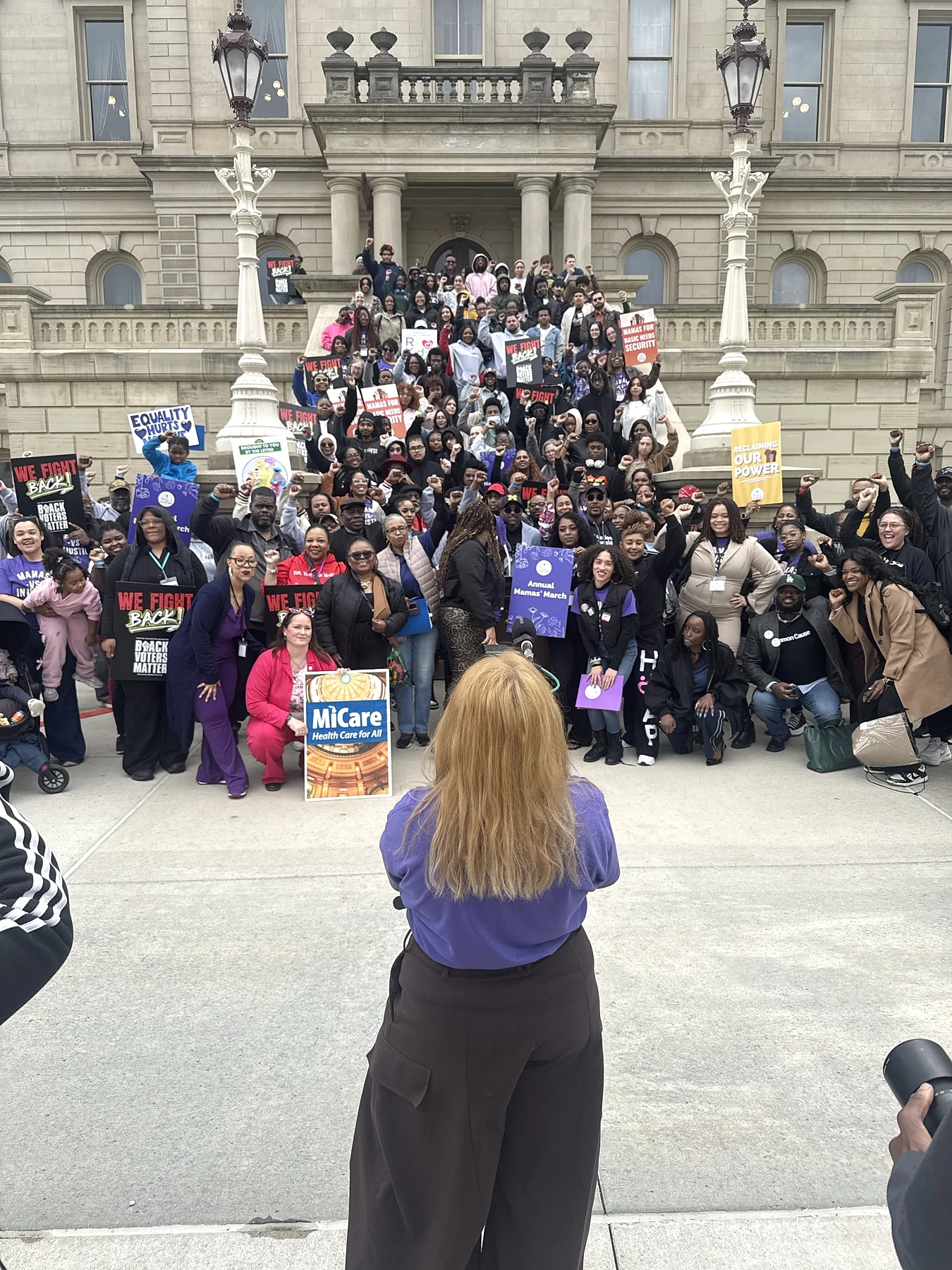 Community advocates gathered on the Michigan Capitol steps
